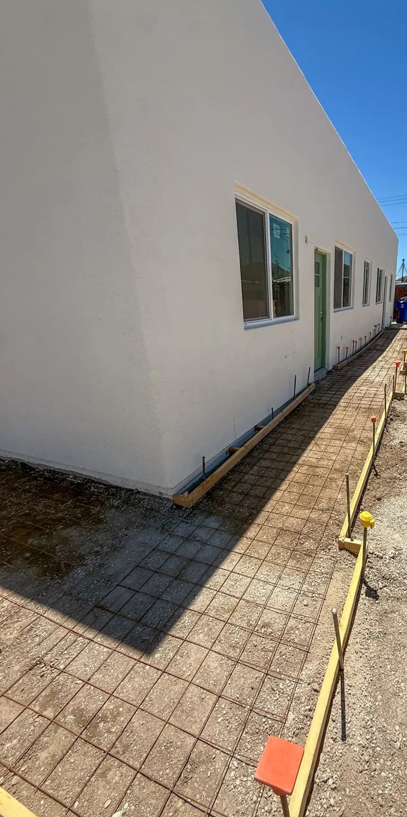 New concrete sidewalk poured beside a Tucson commercial building