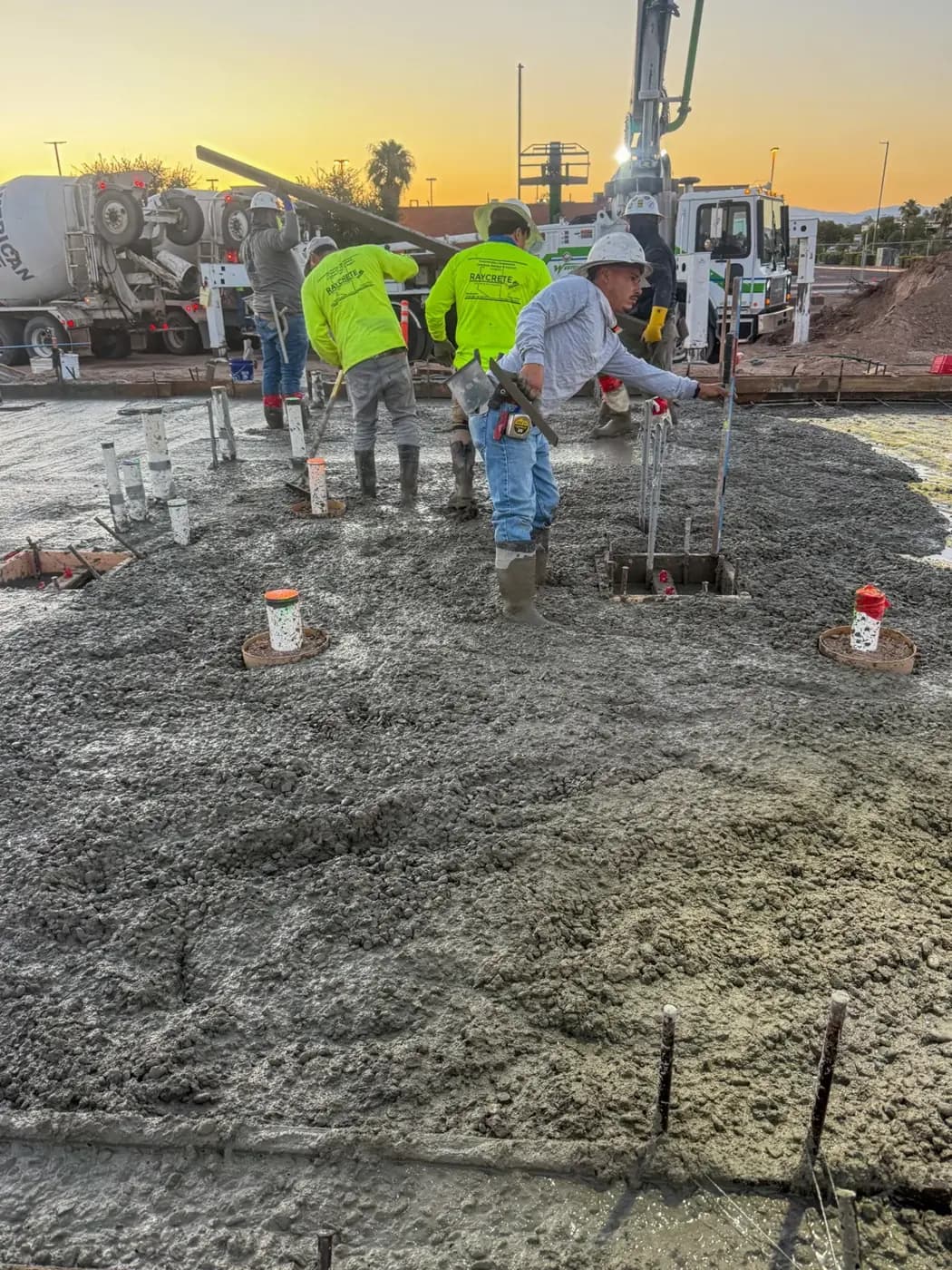 Raycrete crew placing concrete at golden hour